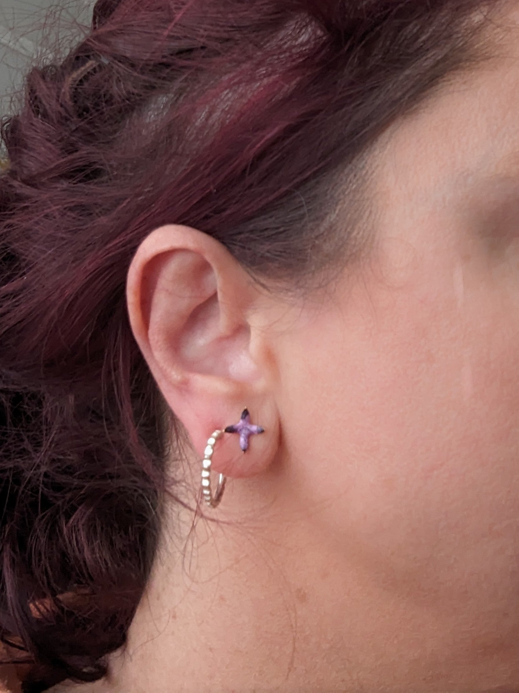 Model wearing stud earrings