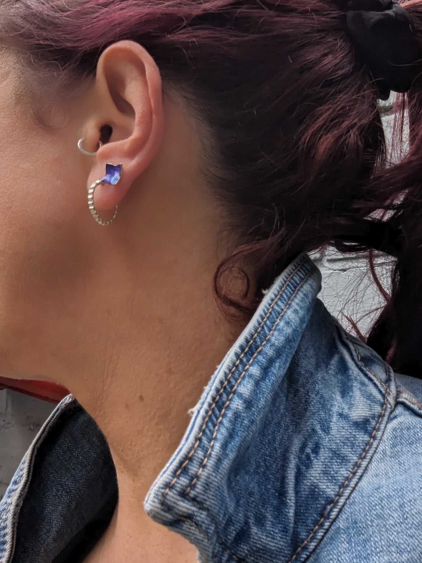 Model wearing blue star studs