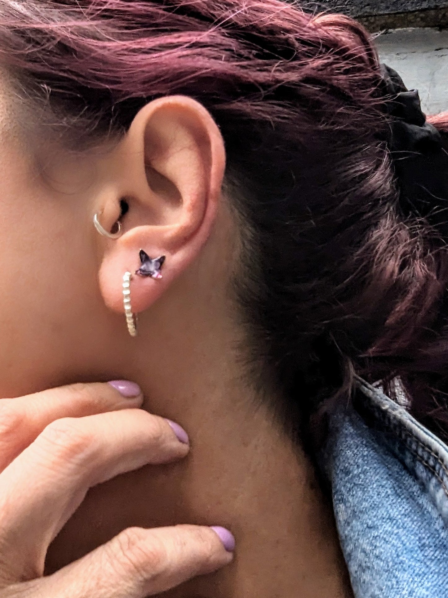 Model wearing stud earrings