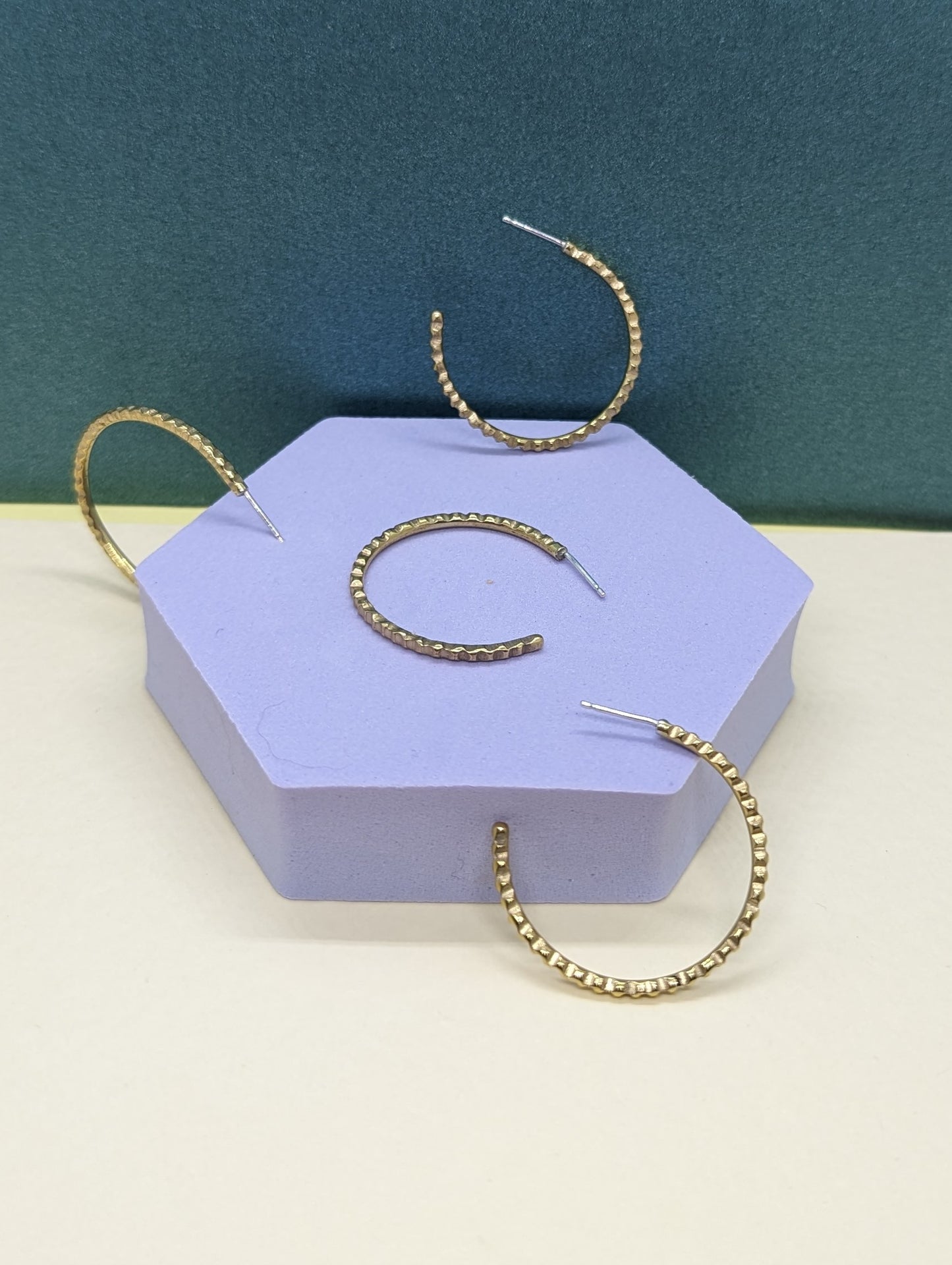 Medium size goddess hoops on display.