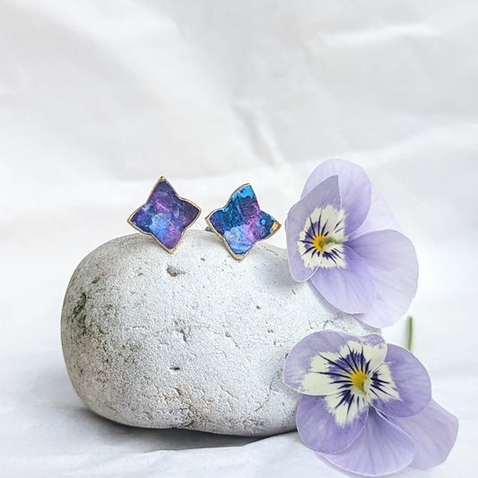 'Theia's Garden' Blue Star Floral Stud Earrings. Earrings displayed on rocks