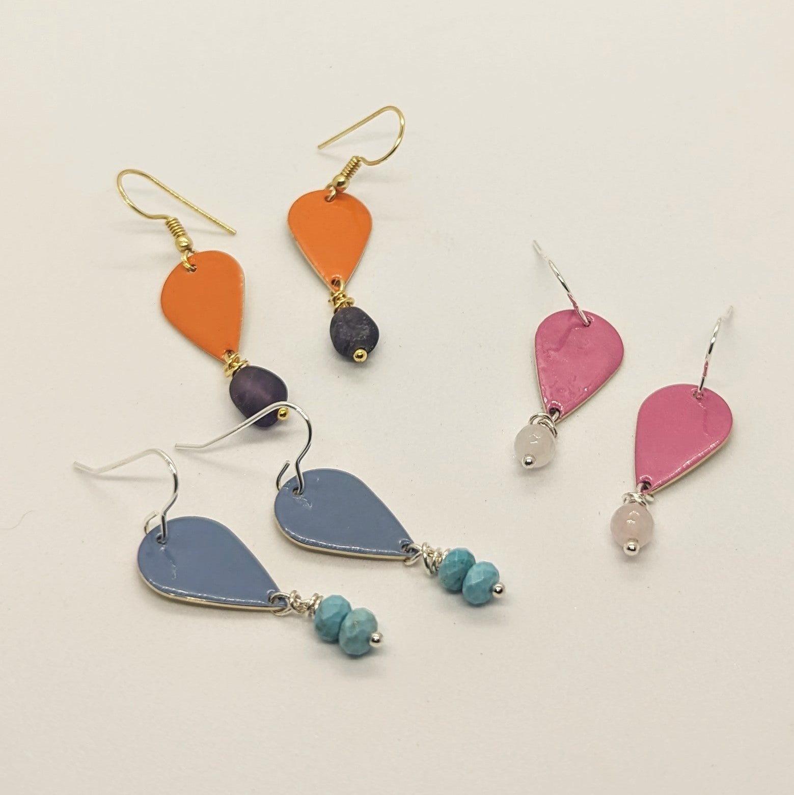 A selection of three pairs or colourful, everyday wear earrings embellished with healing crystals.  colours and crystal pairs included: Orange with Amethyst, Blue with Turquoise, Pink with Rose Quartz  